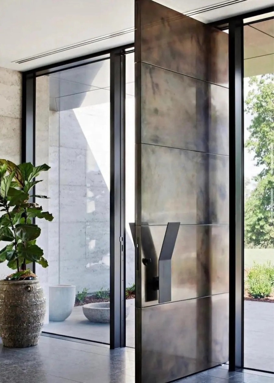 Modern glass door with metal handle in a contemporary interior setting