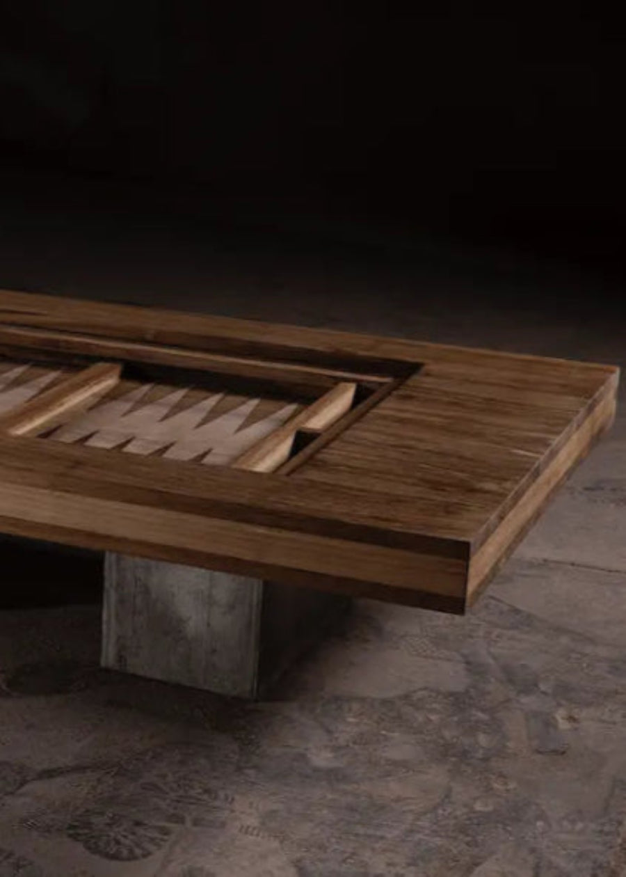 Wooden coffee table with concrete base on a dark floor